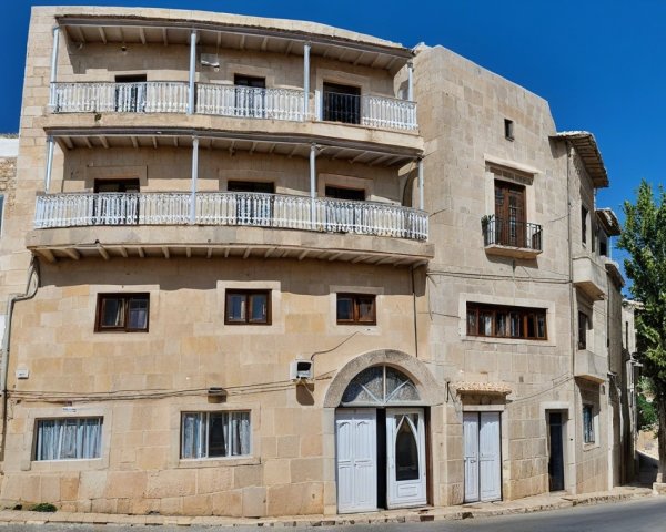 Charming Stone Building with Balconies and Arched Doorways