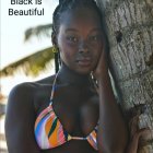 Model in White Bikini Posing on Plush Sofa