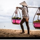 Woman in traditional attire on a sandy beach