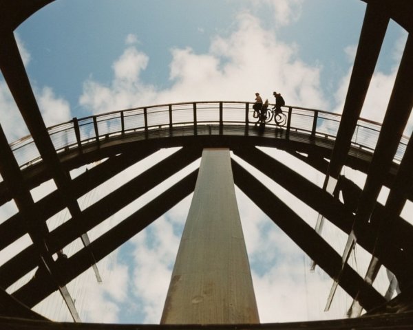 Curved Pedestrian Bridge Under Partly Cloudy Sky