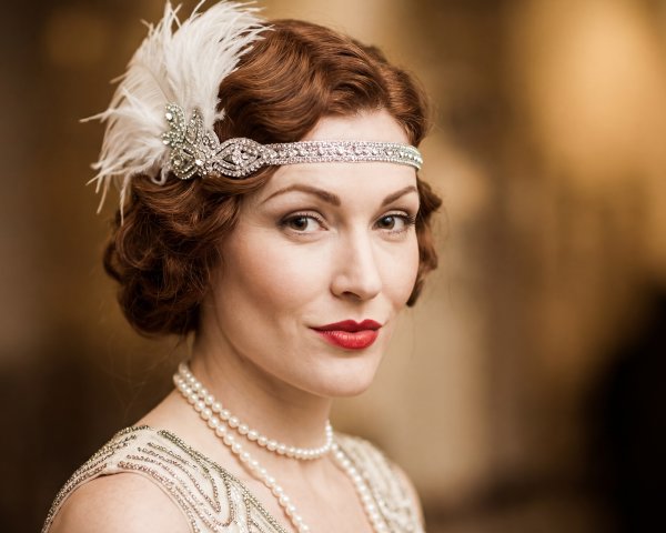 Red-haired woman in flapper dress with accessories