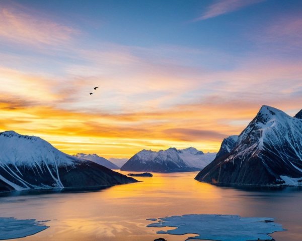 Majestic Snow-Capped Mountains at Vibrant Sunset