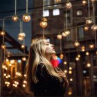 Elegant Woman in Teal Dress at Enchanting Night Market