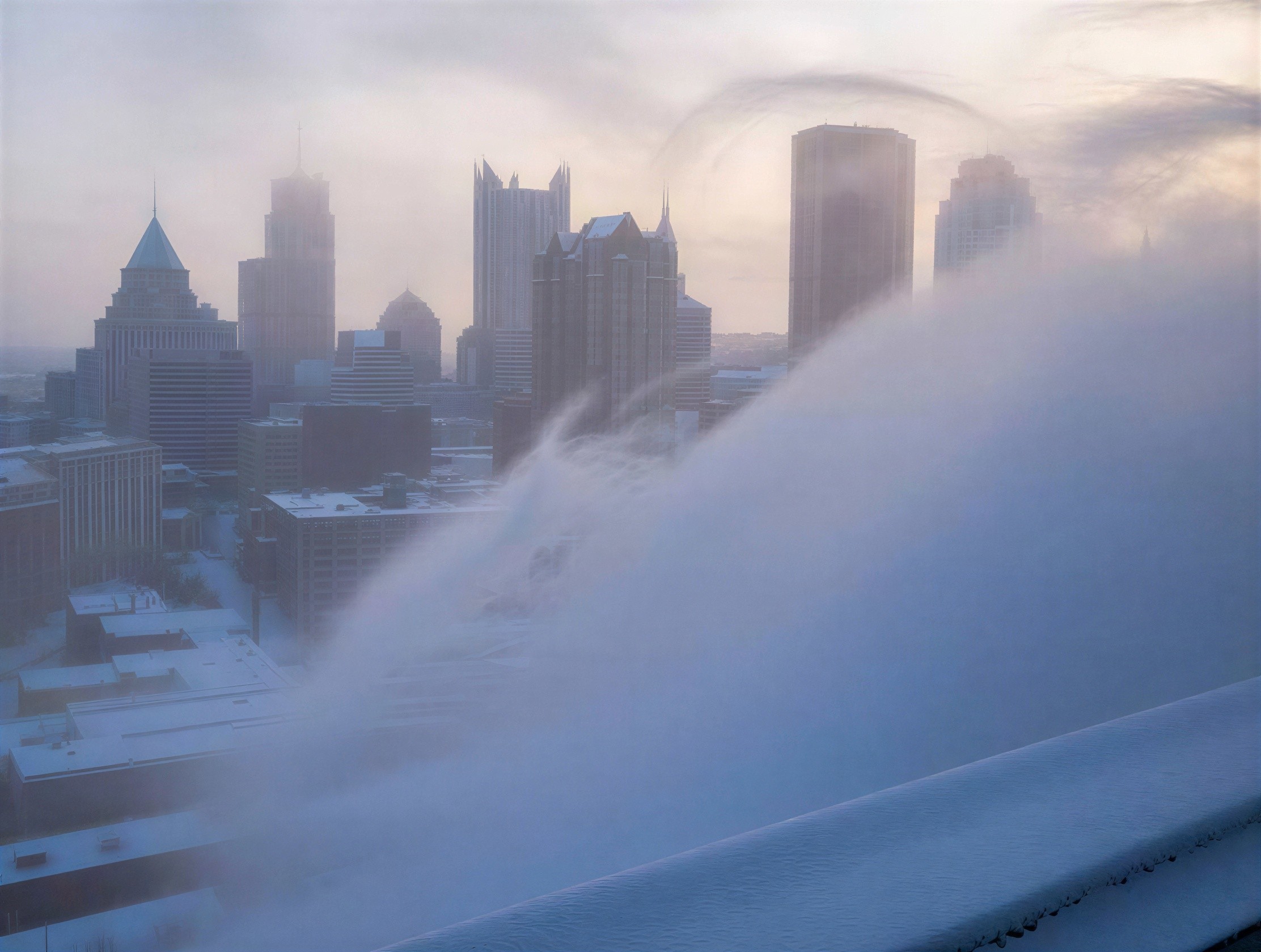 Foggy Cityscape with Snow-Covered Buildings