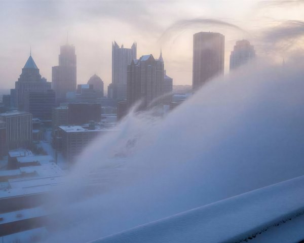 Foggy Cityscape with Snow-Covered Buildings