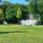 Winter Scene with Children Ice Skating and Houses