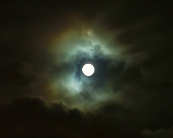 Full Moon Surrounded by Ethereal Clouds and Mist