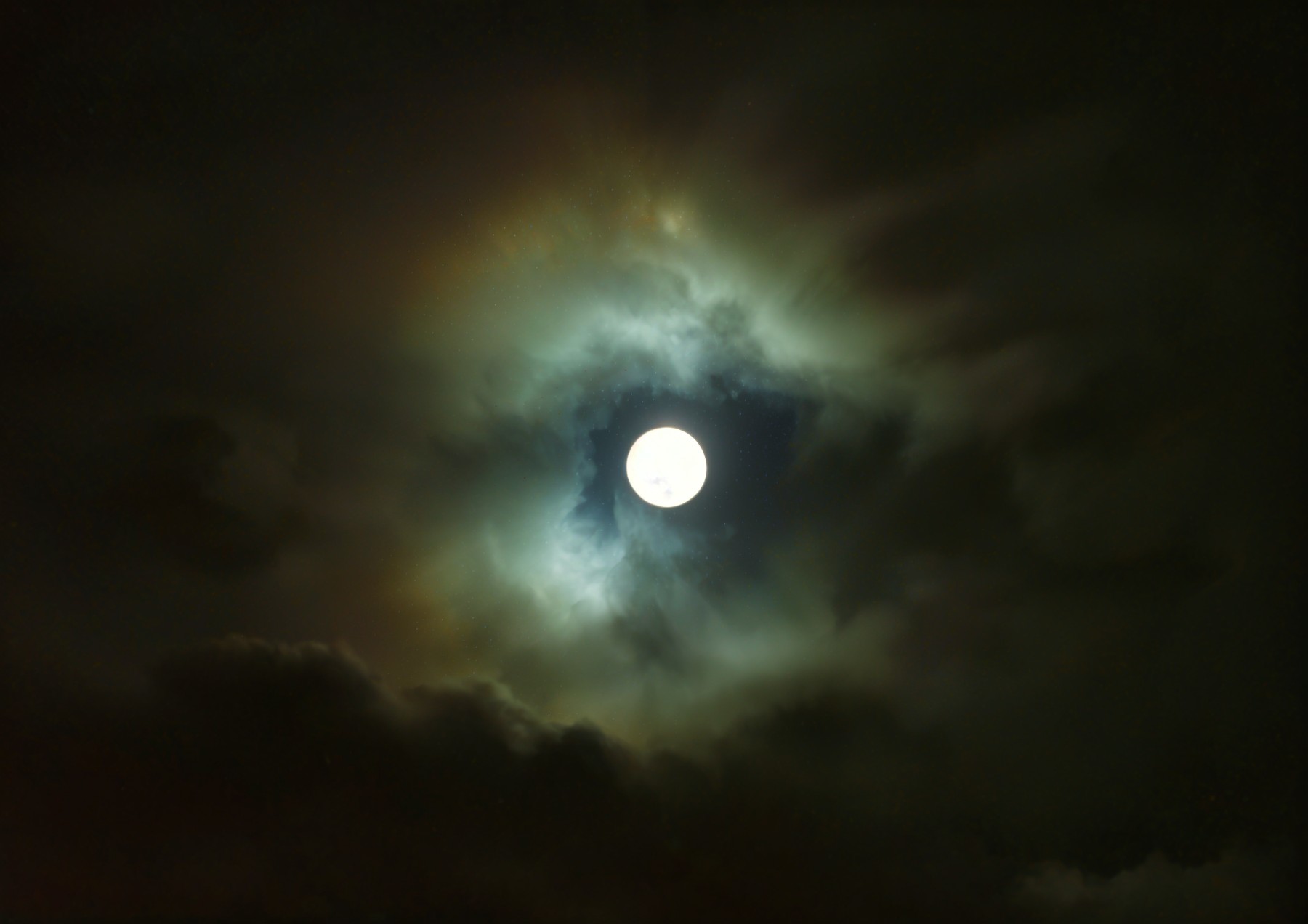 Full Moon Surrounded by Ethereal Clouds and Mist