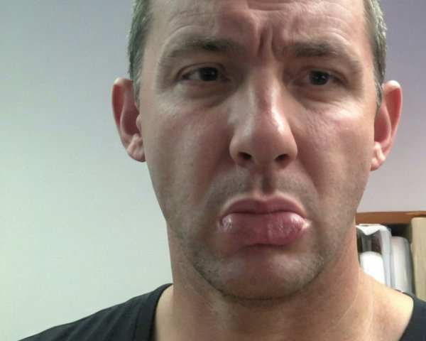 Close-up selfie of a man with fair skin and crew cut