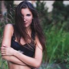 Young Woman Posing in Lush Green Forest Setting