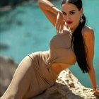 Woman in metallic bikini on a beach with turquoise waters