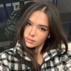 Young woman with flawless skin in cozy polka dot sweater