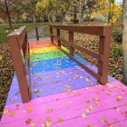 Colorful Wooden Bridge in Lush Autumn Forest