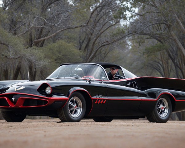 Vintage Black Car with Red Accents on Tree-Lined Path