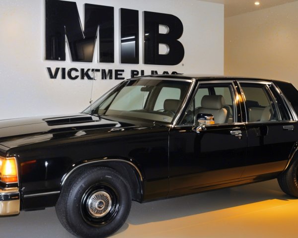 Classic Black Sedan in Modern MIB-Themed Setting