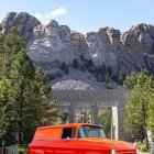 Red Vintage Van at Mount Rushmore with Scenic Background