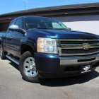 Shiny Blue Chevrolet Pickup Truck in Front of Garage