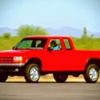Vibrant Red Pickup Truck Against Clear Blue Sky