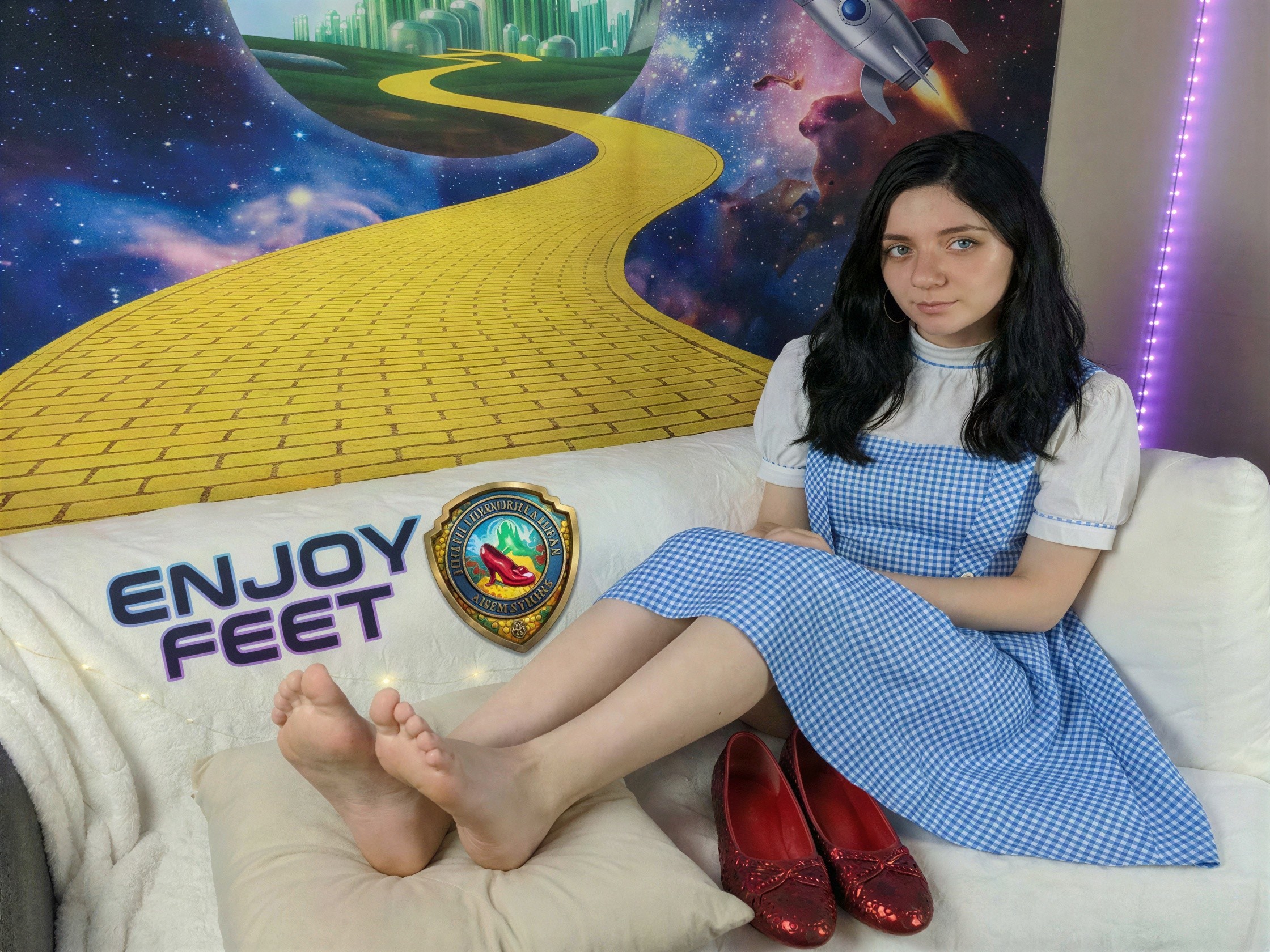 Fair-skinned woman in blue dress on white couch
