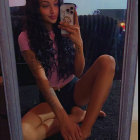 Young woman with tattoos in cozy living room setting