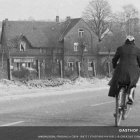 Cyclist on Scenic Path with Charming House Background