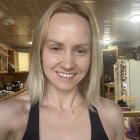 Smiling Woman in Stylish Room Taking a Selfie
