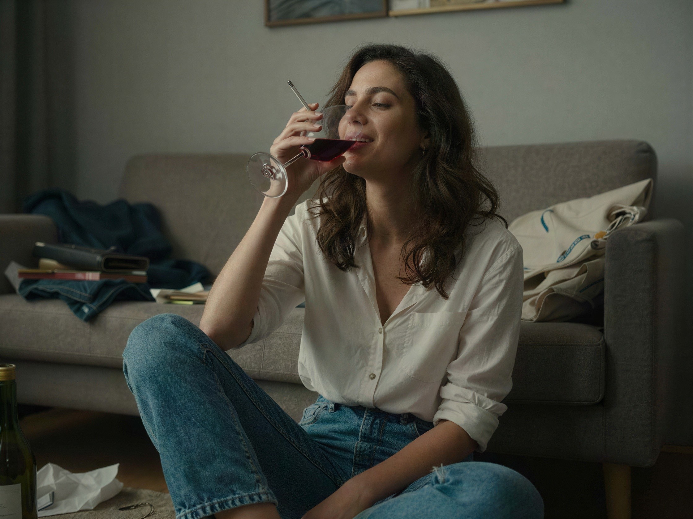 Woman in Living Room Enjoying Wine and Cigarette