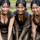 Women Playing in Muddy Field with Matching Outfits