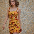 Young Woman in Vibrant Yellow Dress with Abstract Background