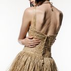 Woven Straw Outfit with Fringe and Soft Lighting