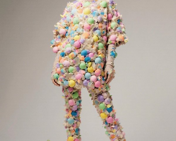 Model in Avant-Garde Outfit with Colorful Pom-Poms