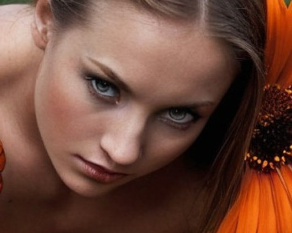 Close-Up Portrait of a Woman Among Orange Flowers