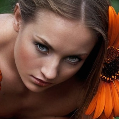 Close-Up Portrait of a Woman Among Orange Flowers