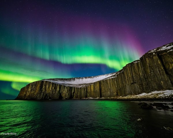 Northern Lights Over Rocky Cliff and Dark Bay