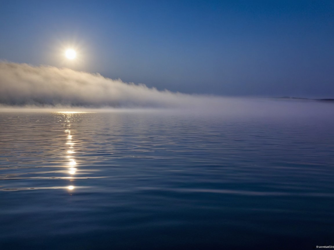 Tranquil Landscape with Reflective Water and Mist