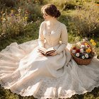 Young Woman in Vintage Gown on Lush Meadow