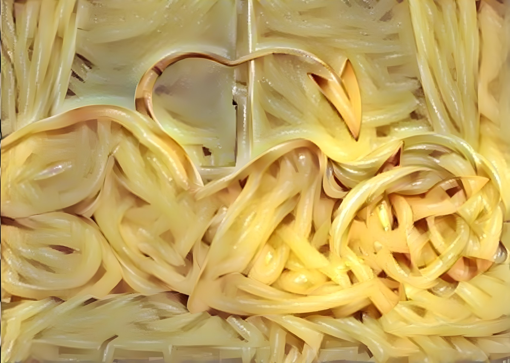 Golden Spaghetti Noodles Form Heart Shape Arrangement