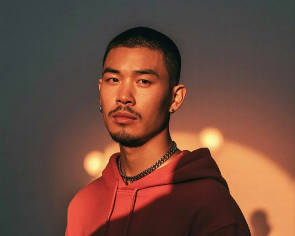 Young man in oversized hoodie with warm lighting