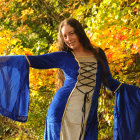 Woman in Elegant Gown Surrounded by Autumn Forest