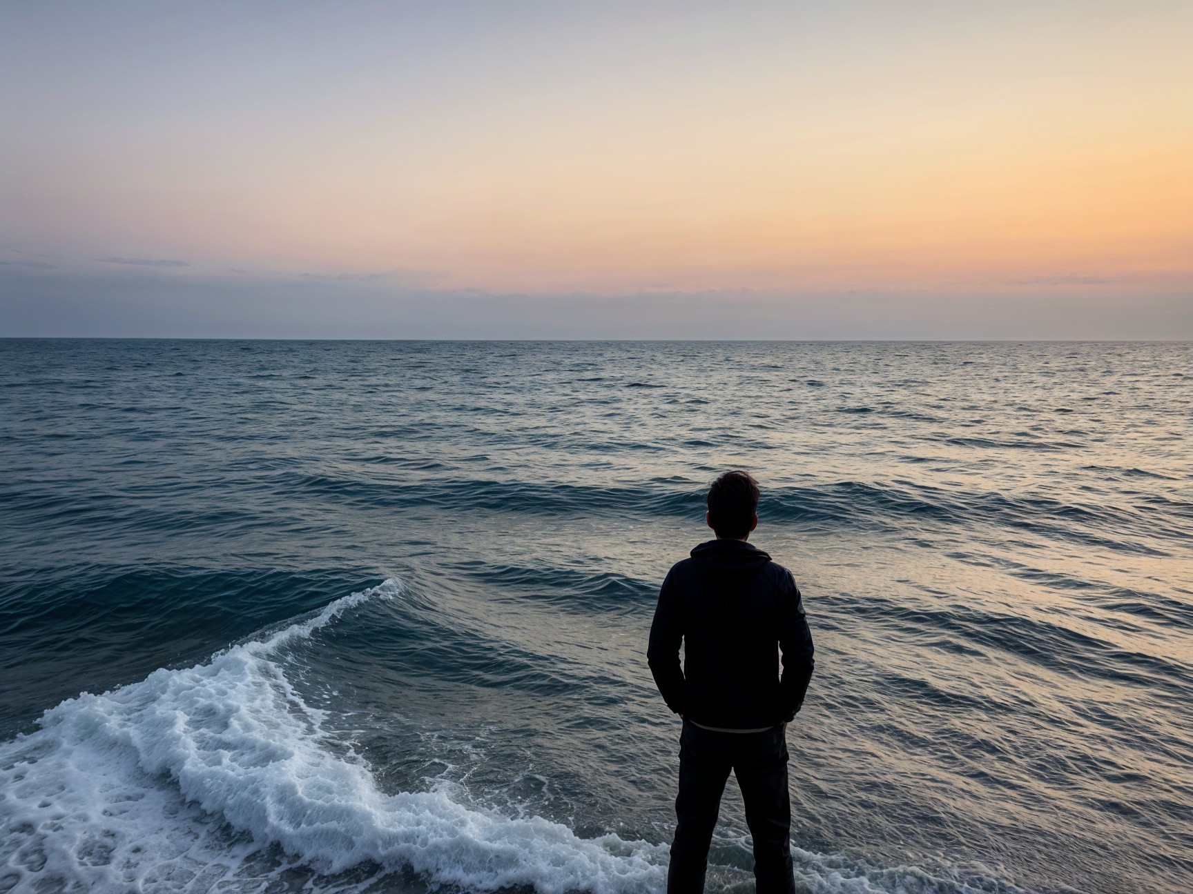 Solitary Figure at Sunset by the Calm Sea