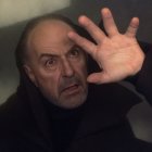 Middle-aged man with green eyes in stormy backdrop