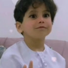 Young child with black hair and curious expression