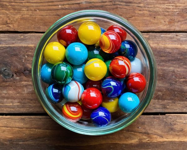 Colorful Glass Marbles in a Rustic Wooden Bowl