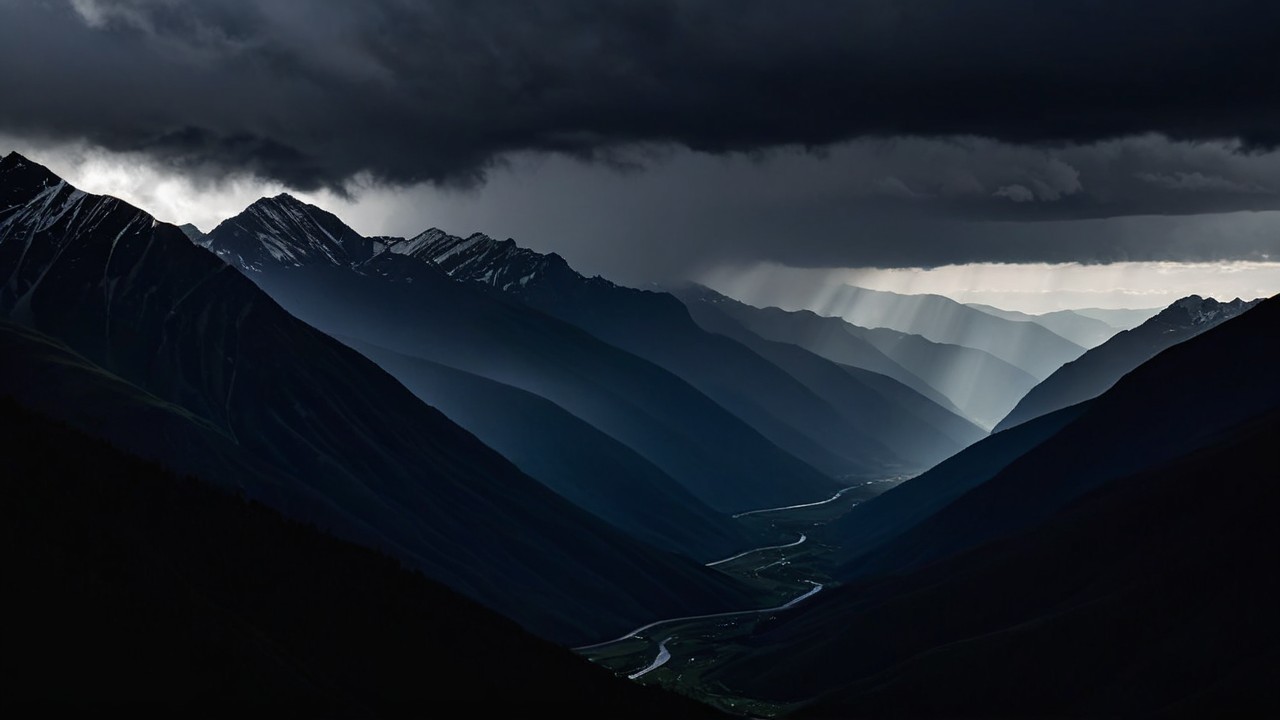 Rugged Mountains Under Dramatic Sky with Light Shafts