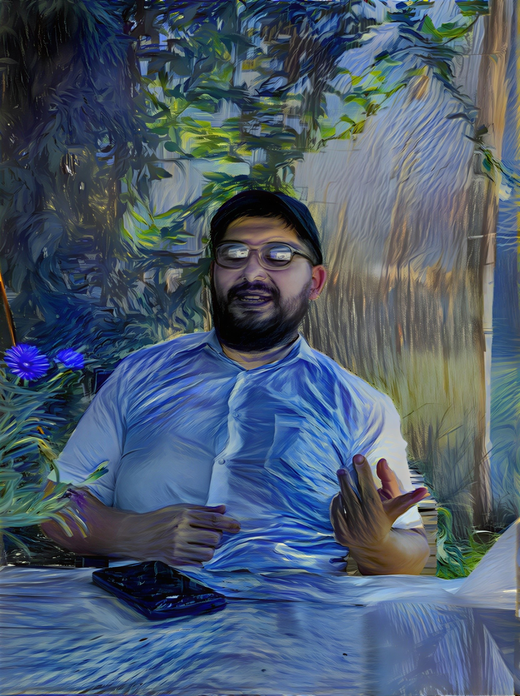 Man at Table Surrounded by Greenery and Flowers