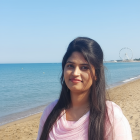 Young woman in pink outfit on serene beach scene