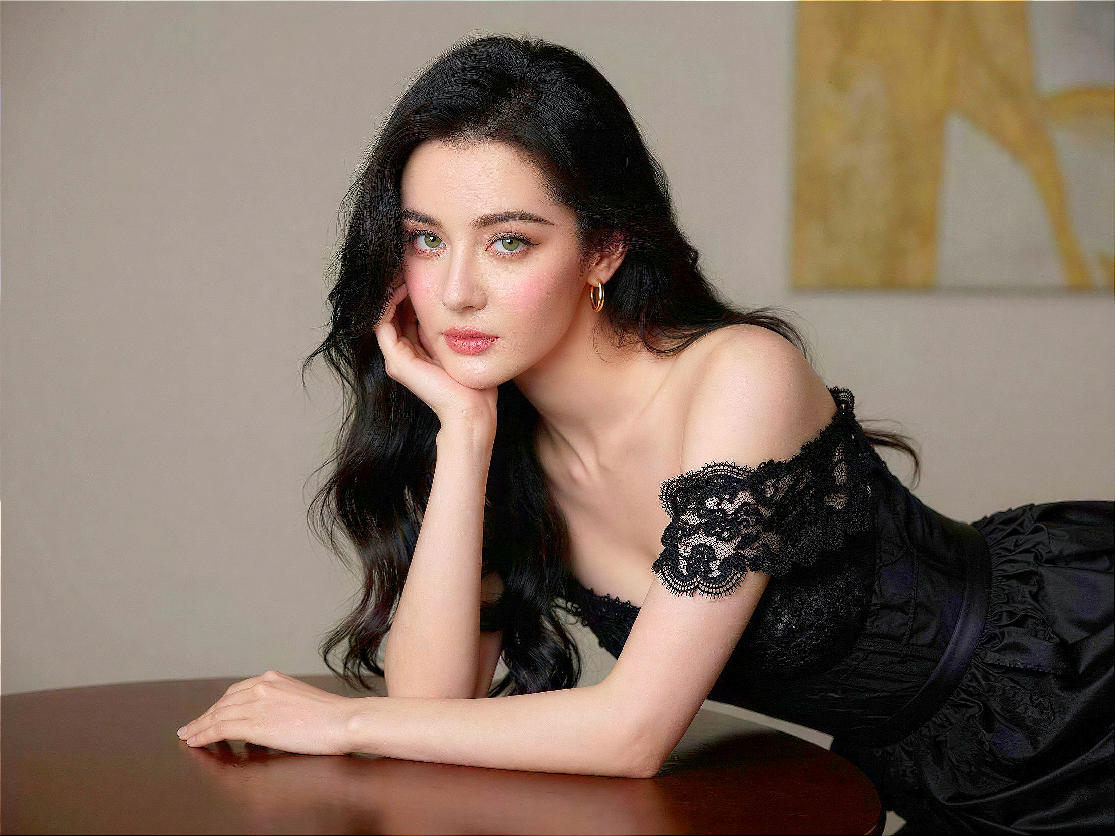 Young woman in black lace dress with neutral expression