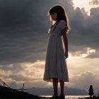 Young girl in white dress in a dramatic landscape
