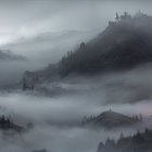 Misty Landscape with Ominous Castle and Eerie Glow