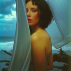 Contemplative Figure by the Shore with Sheer Fabric